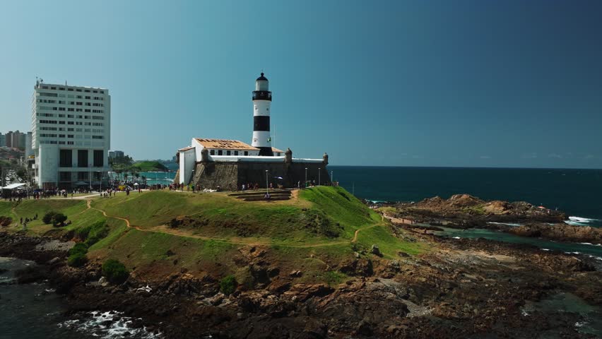 Aerial view of Salvador da Bahia cityscape, Barra Lighthouse, beach and azure sea. Tropical Travel Destination. Aerial landscape of Coastal City. Salvador, Bahia, Brazil.