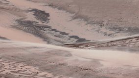 Wind shaping sand dunes in a desert landscape with soft patterns and textures formed by natural elements. Subtle wind gusts moving fine sand over the dune surface - Powered by Shutterstock - Get 15% off with code: PIKWIZARD15