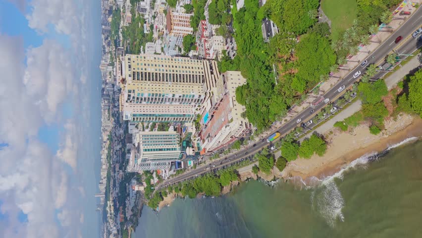 Vertical aerial, Santo Domingo city skyline with modern buildings and highway