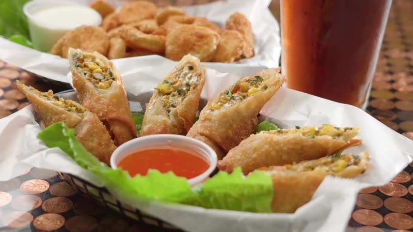 Old school Food Basket stuffed with Southwest Egg Rolls and Sweet and Sour Dipping Sauce.