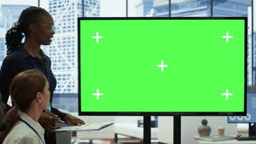 Diverse work team discusses corporate strategies with a big green screen, meeting in high end boardroom to examine market trends. Sharing new ideas for business growth and expansion. Camera A. - Powered by Shutterstock - Get 15% off with code: PIKWIZARD15