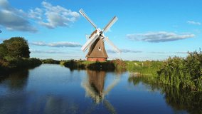 Beautiful wooden windmills at sunset in the Dutch village. The beautiful Dutch canals filled with water. Beautiful sunset. - Powered by Shutterstock - Get 15% off with code: PIKWIZARD15