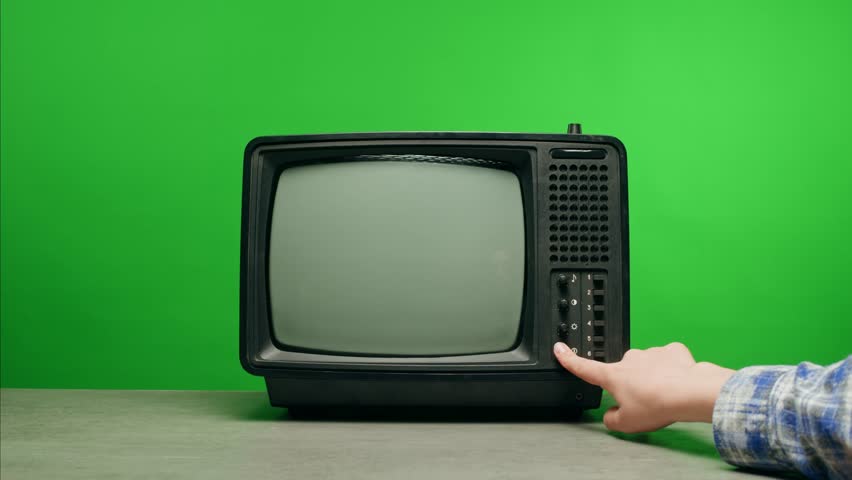 In a nostalgic setup, a retro TV displays static on its screen, reminiscent of an era gone by