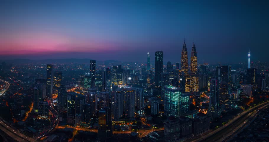 Kuala lumpur skyline transforming with growing glowing lines at dusk