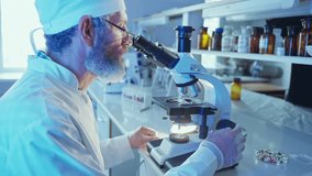 A chemist examines samples through a microscope in a vibrant laboratory filled with advanced equipment. - Powered by Shutterstock - Get 15% off with code: PIKWIZARD15