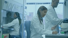 Animation of network of people icons over diverse scientists at work in laboratory. Connection, medical research, data, science, digital interface and communication, digitally generated video. - Powered by Shutterstock - Get 15% off with code: PIKWIZARD15