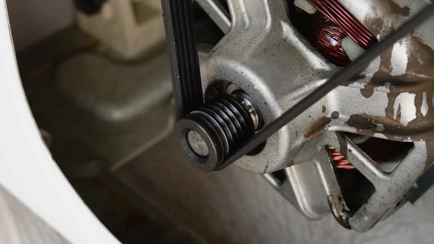 Close-up video of a rotating washing machine motor. Washing machine repair concept. 