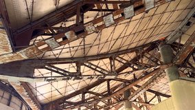 Rusted framework forms intricate grid pattern in abandoned desert structure. Columns hold up weathered panels, revealing industrial decay and desolation after years of exposure. - Powered by Shutterstock - Get 15% off with code: PIKWIZARD15