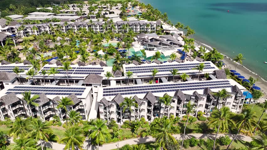 Aerial view of luxury resort hotel with pool, palm trees at Denarau Island beachside. Exotic destination, Fiji.