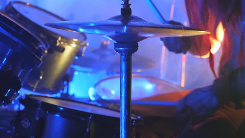 Unrecognizable professional drummer playing on the drum by wooden sticks during rock concert. Music drums set. Close up Slow motion