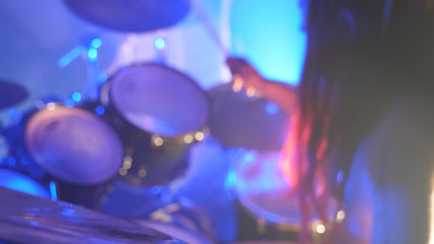 Unrecognizable professional drummer playing on the drum by wooden sticks during rock concert. Music drums set. Close up Slow motion