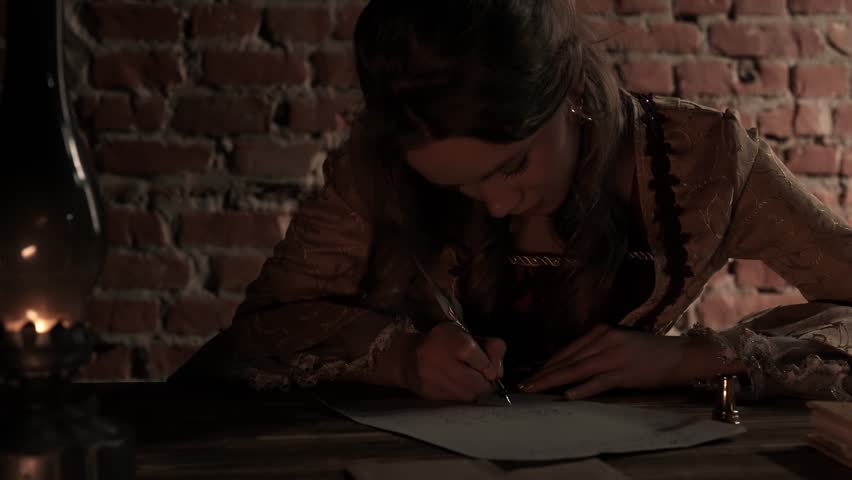 Antique young woman in renaissance dress sitting writing letter with vintage quill pen with ink on old parchment papers sheet in darkness of candlelight.