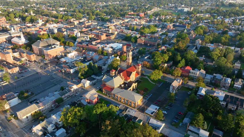 Aerial view of Carlisle, Pennsylvania, featuring a mix of historic buildings, residential areas, and tree-lined streets on a clear day.