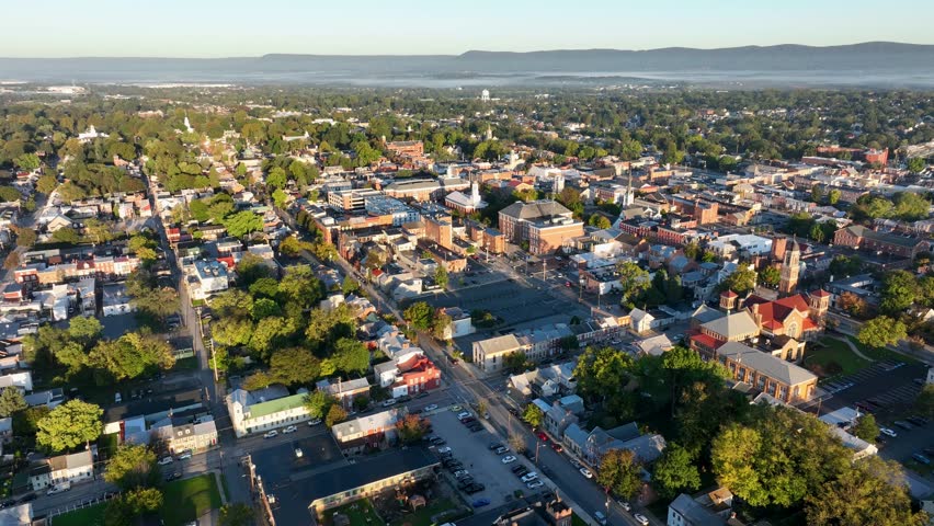 Aerial view of Carlisle, Pennsylvania, featuring a mix of historic buildings, residential areas, and tree-lined streets on a clear day.