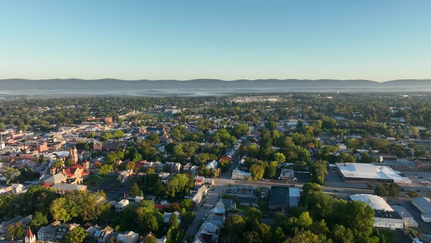 Aerial view of Carlisle, Pennsylvania, featuring a mix of historic buildings, residential areas, and tree-lined streets on a clear day.