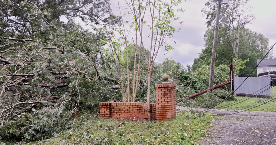 Tornado hurricane damaged fences around house when trees fell