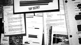 Camera moves through various top secret and classified government documents. Leaked information or confidential paper exposed or declassified. Hidden with redacted black lines covering sensitive text - Powered by Shutterstock - Get 15% off with code: PIKWIZARD15