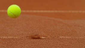 Super slow motion of Tennis ball ping white line on clay court . Filmed on high speed cinematic camera at 1000 fps . - Powered by Shutterstock - Get 15% off with code: PIKWIZARD15