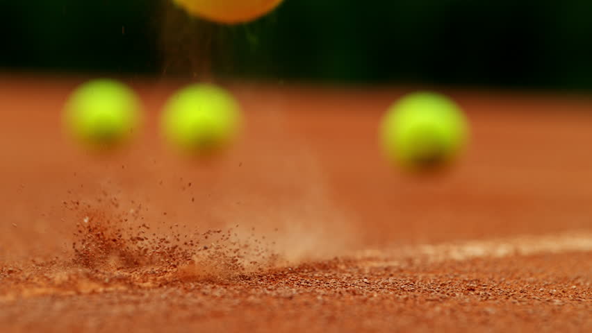 Super slow motion of Tennis ball ping on clay court inside or outside white line . Filmed on high speed cinematic camera at 1000 fps .