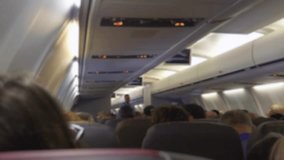 Blurry cabin view of passengers on a flight in 4k slow motion 60fps - Powered by Shutterstock - Get 15% off with code: PIKWIZARD15
