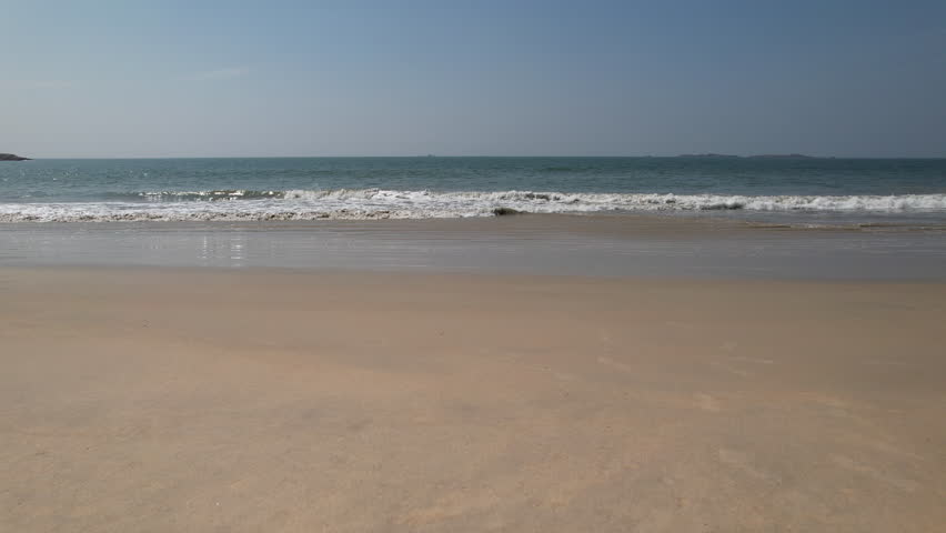 Drone view of Malpe Beach in Karnataka, India with ocean and coconut trees 