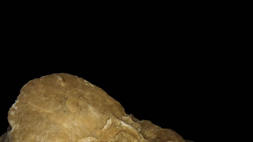 A desert rose is an rose-like formation of crystal clusters of gypsum or baryte, which include abundant sand grains - macro, close-up video clip of its surface. 