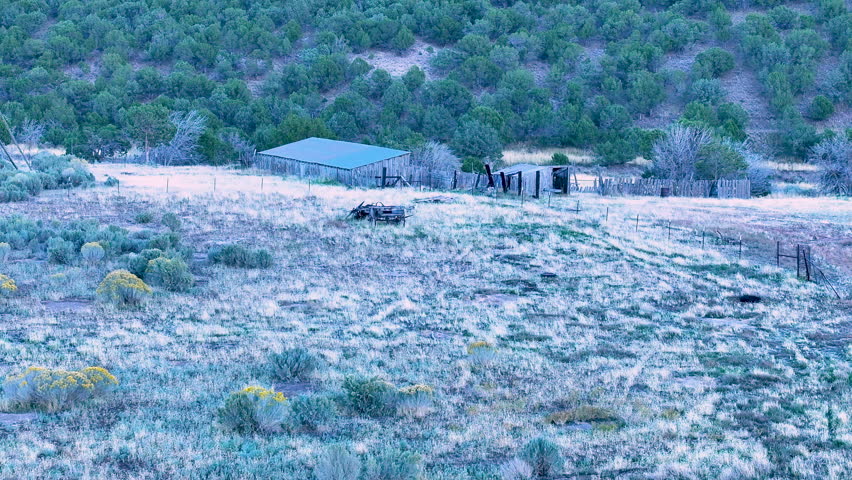 Aerial old pioneer wagon corral Utah. Antique farm homestead buildings and equipment abandoned in rural community. Farming agriculture Utah. Animal livestock corrals, fences and stock buildings.