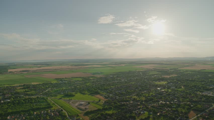 Beautiful scenic view of Hungarian rural area from the air. Wide angle view of a rural area in summer. Green ladscape. Hot air ballon before sunset in summer.