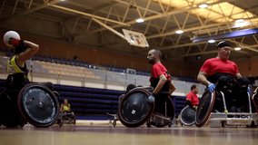 Wheelchair rugby paralympic athletes strategizing with their team during a timeout in a brightly lit gymnasium - Powered by Shutterstock - Get 15% off with code: PIKWIZARD15