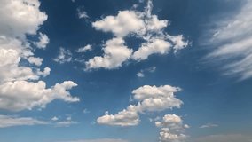 Clouds fly forward in the blue skies. 4K video (Ultra High Definition) of cloudscape. Sky and clouds Timelapse. Sun shines through the clouds on the blue sky background. - Powered by Shutterstock - Get 15% off with code: PIKWIZARD15