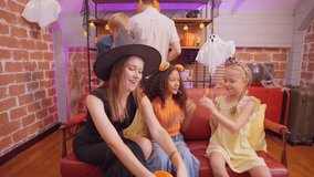 Multiracial family celebrating Halloween party together in house. Attractive parents and their children dressed in Halloween costumes enjoy spend time during holiday festival in living room at home. - Powered by Shutterstock - Get 15% off with code: PIKWIZARD15