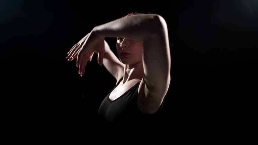 Fascinating ballet performance, back view of ballerina in pointe shoes and tutu. Beauty and grace of female body, professional ballet dancer rehearsing alone in dark dance hall, power and tenderness - Powered by Shutterstock - Get 15% off with code: PIKWIZARD15