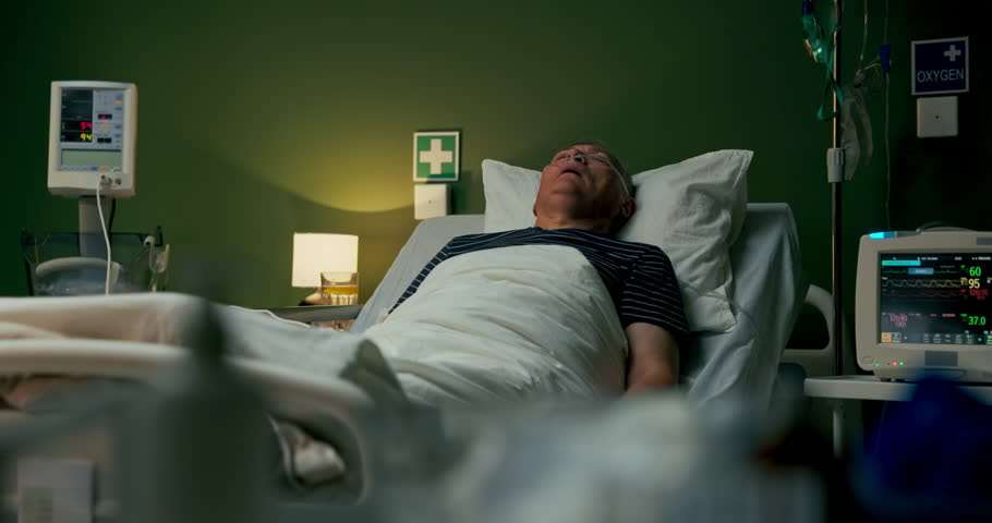 Successful organ transplant recovery, closed-eyed senior patient with oxygen tube.