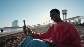 Young African American woman makes selfie video for social media with smartphone on sunny beach. Social media influencer, enjoying travel time on seaside during vacations holidays, using technology - Powered by Shutterstock - Get 15% off with code: PIKWIZARD15