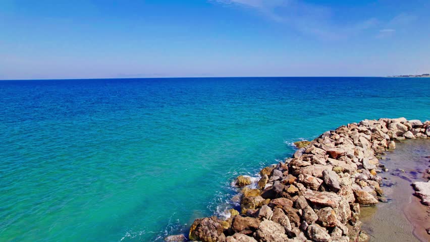 Discover Tranquil Coastal Views at Sunrise Along the Rocky Shoreline in a Serene Seaside Location