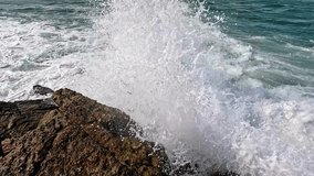 Ocean waves crash against rocks in slow motion, creating a dramatic and cinematic effect. Perfect for projects requiring dynamic and powerful nature scenes. - Powered by Shutterstock - Get 15% off with code: PIKWIZARD15