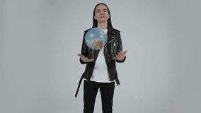 Young guy with long hair is spinning the planet Earth in his hands in the form of a spherical globe. White background  - Powered by Shutterstock - Get 15% off with code: PIKWIZARD15