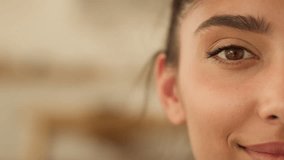 Close up half face Indian ethnic woman cropped view Arabian girl Latina female lady looking at camera eyesight health smiling eye eyeliner mascara makeup at home indoor feminine human positive happy - Powered by Shutterstock - Get 15% off with code: PIKWIZARD15