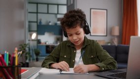 African American son male kid child boy pupil student schoolboy study at home with laptop computer studying distant learning homework e-learning writing online education listening music in headphones - Powered by Shutterstock - Get 15% off with code: PIKWIZARD15