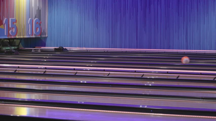 Background of bowling balls rolling through the lanes under neon lights
