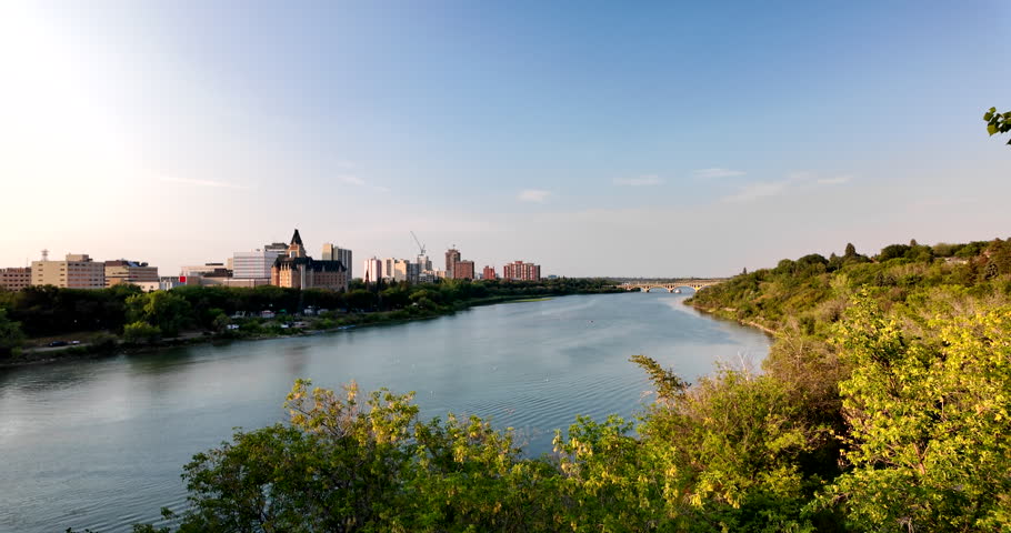 City skyline of downtown Saskatoon reflects along the South Saskatchewan River