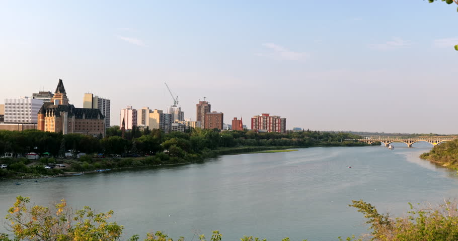 City skyline of downtown Saskatoon reflects along the South Saskatchewan River