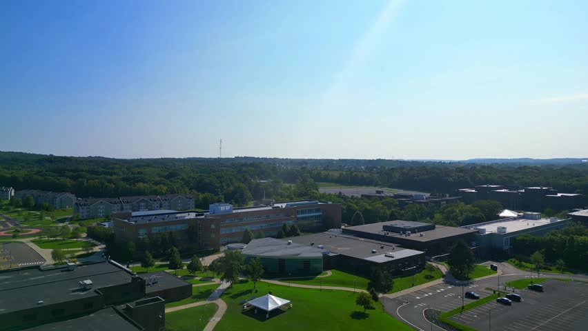 Ascending towards the sky, the recording spirals down to the ground, offering a view of a beautiful college campus that radiates inspiring grandeur.