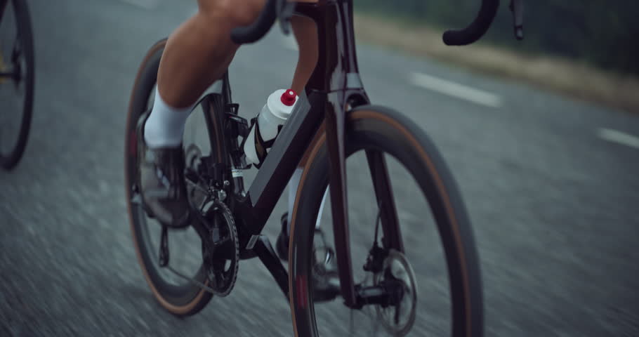 Cyclists in Colorful Jerseys Race Through Misty Landscapes, Showcasing Speed, Focus and Teamwork. Dynamic Ride Captures the Essence of Competitive Cycling and the Thrill of Outdoor Adventure