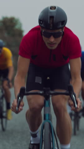Vertical Screen: One Athlete Rides at the Front, Setting the Pace for Two Cyclists Trailing Behind. Professional Team Power Through the Long Road, Training for Peak Performance Before the Championship