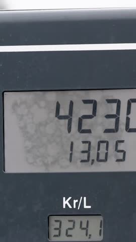 Gas station fuel meter counter price. Close up while refueling a car. Increasing petrol costs. Number of Kr per Li