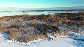 Aerial footage of frozen winter sea and island archipelago covered in snow. Red seaside cabin.  - Powered by Shutterstock - Get 15% off with code: PIKWIZARD15