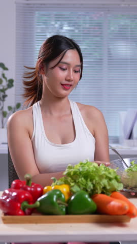 Young woman is showing a healthy salad and making positive gestures, promoting a healthy lifestyle