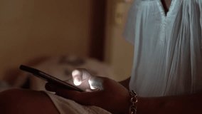 Close up of woman's hands using her cell phone, surfing on the social media before bed time in the dark - Powered by Shutterstock - Get 15% off with code: PIKWIZARD15