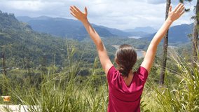 Woman tourist standing at the edge of beautiful canyon and victoriously outstretching arms up. Young female hiker reaching up top of mountain and raised hands. Close up - Powered by Shutterstock - Get 15% off with code: PIKWIZARD15